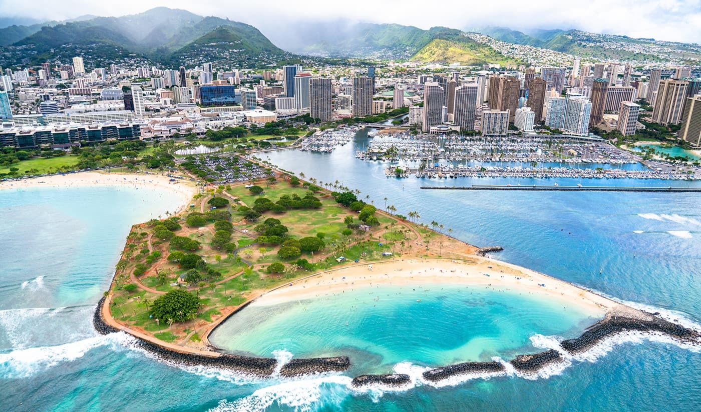 Aerial view of Waikiki and Magic Island near The Equus Hotel