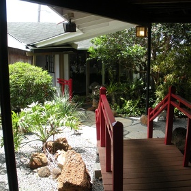 Garden entrance with red bridge at Natsunoya Tea House